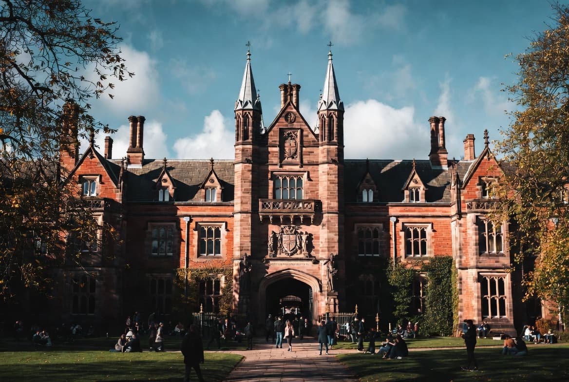 Students on the lawn in front of the main quadrangle